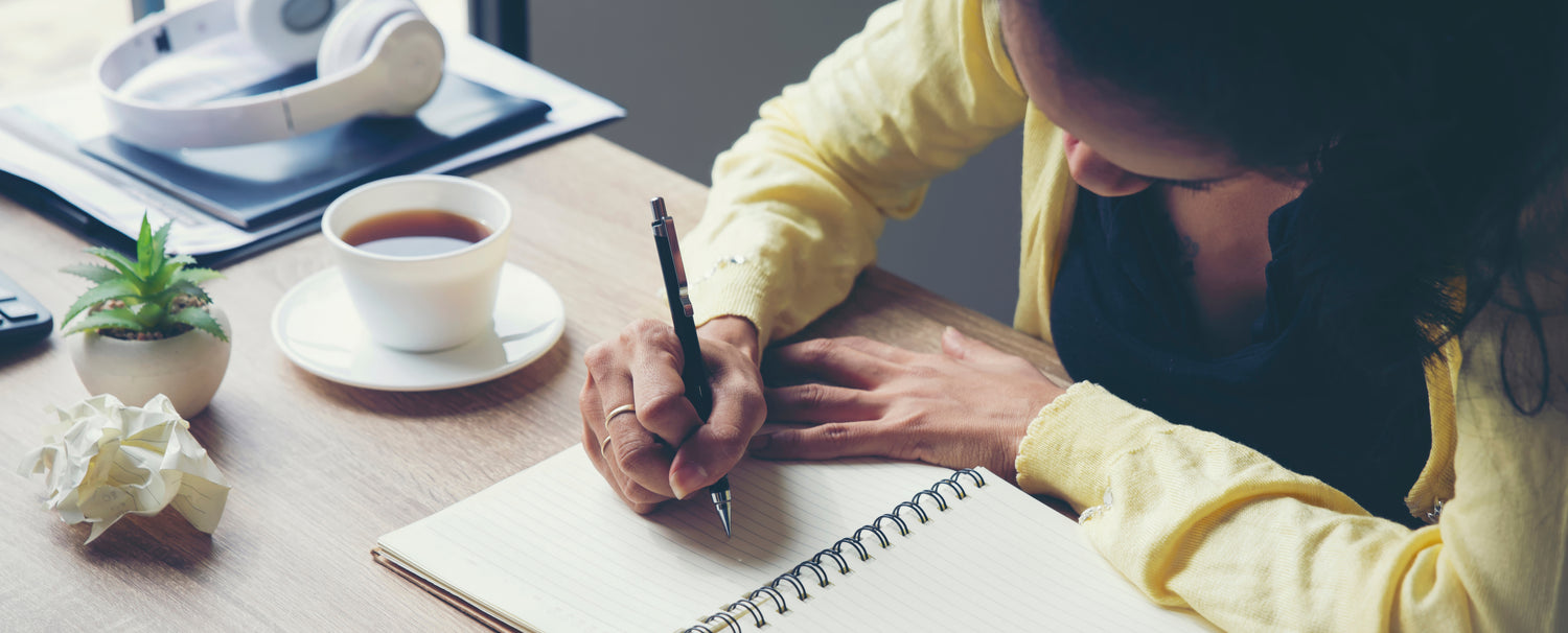 Woman writing in a journal